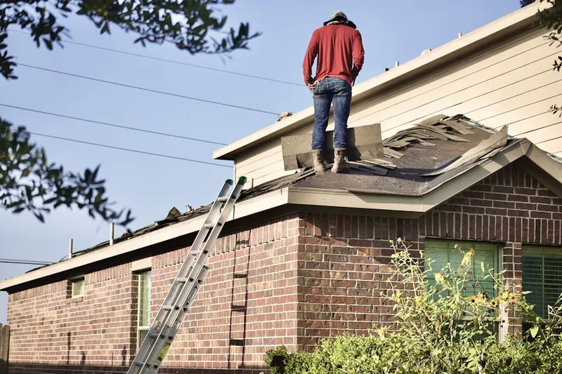 Professional roofer working on a residential roof in Lula